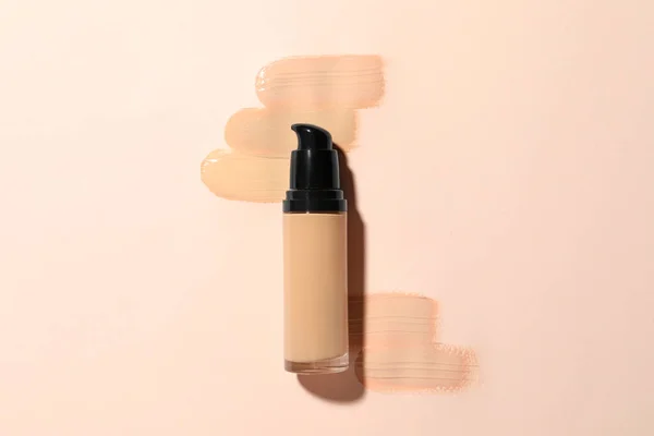 stock image Liquid foundation and swatches on beige background, top view