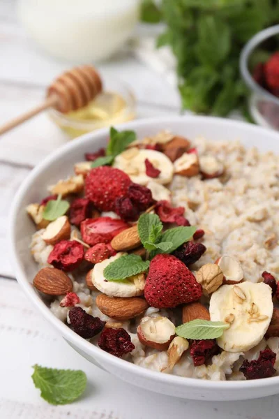 Delicious Oatmeal Freeze Dried Berries Banana Nuts Mint White Table — Stock Photo, Image