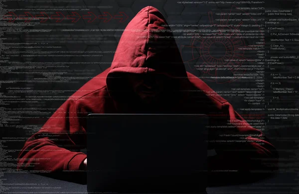 Cyber attack. Anonymous hacker working with laptop on black background. Different digital codes and icons around him