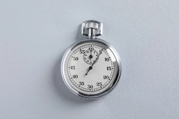 Vintage timer on light grey background, top view. Measuring tool