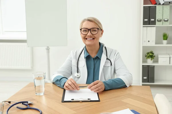 Επαγγελματίας Γιατρός Κάθεται Ξύλινο Τραπέζι Στην Κλινική — Φωτογραφία Αρχείου