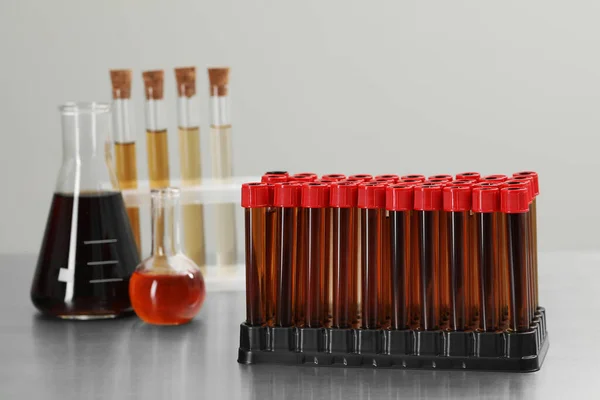 Different Laboratory Glassware Brown Liquids Table Light Background — Stockfoto