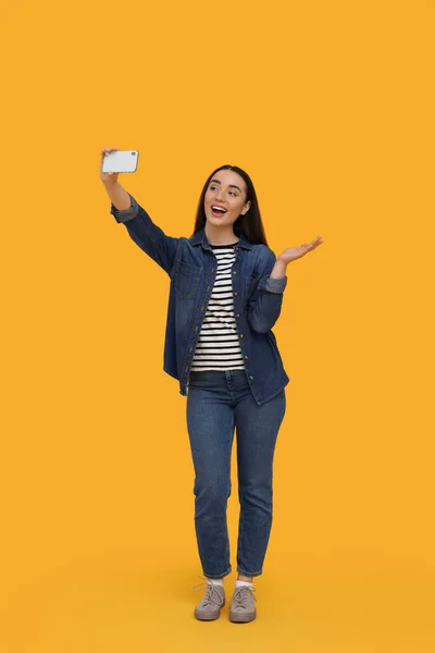 Lächelnde Junge Frau Macht Selfie Mit Smartphone Auf Gelbem Hintergrund — Stockfoto