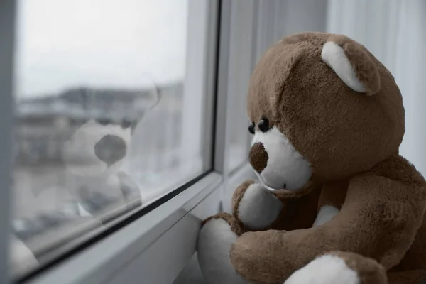 stock image Cute lonely teddy bear on windowsill indoors, closeup. Space for text