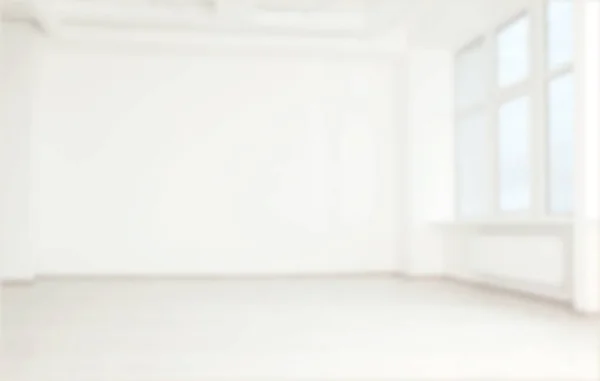 Empty room with white wall and window, blurred view