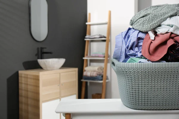 Laundry Basket Filled Clothes Table Bathroom Closeup Space Text — стоковое фото