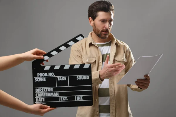 Actor Performing While Second Assistant Camera Holding Clapperboard Grey Background — Stock fotografie