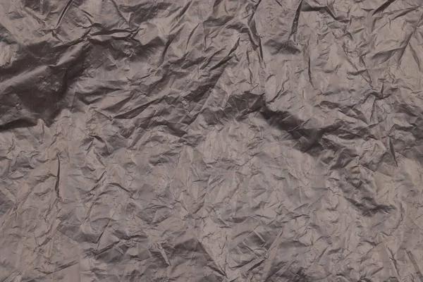 Zgnieciona Czarna Plastikowa Torba Jako Tło Widok Góry — Zdjęcie stockowe