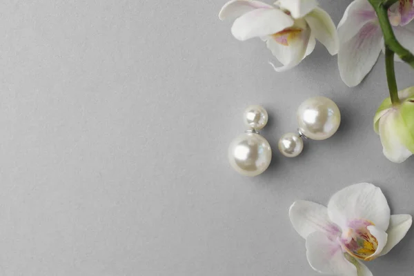 Elegantes Pendientes Perlas Flores Orquídea Sobre Fondo Blanco Planas Espacio —  Fotos de Stock