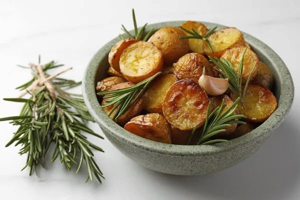 白桌上有美味的烤土豆和芳香的迷迭香 — 图库照片
