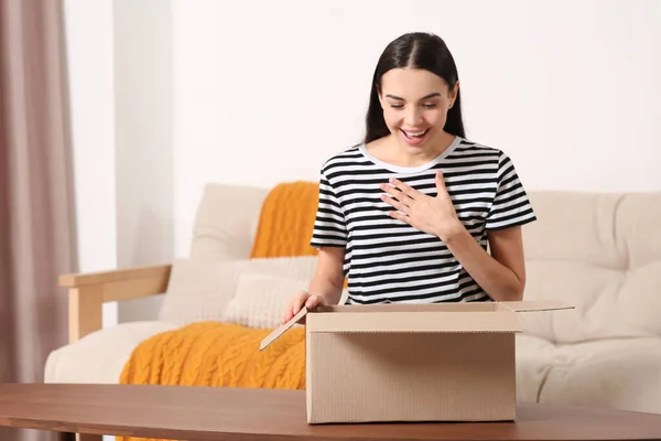 Emotional Young Woman Opening Parcel Home Internet Shopping — Stock Photo, Image