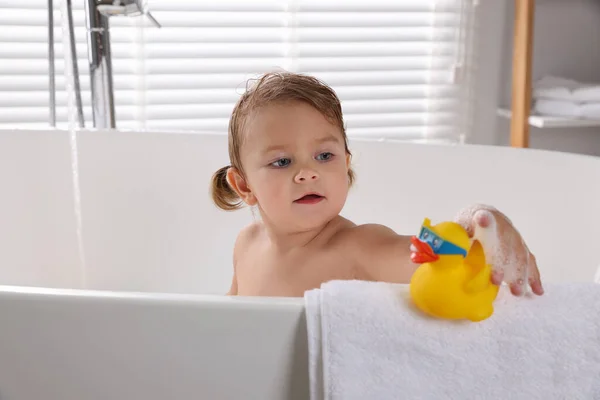 Cute Little Girl Taking Bath Toy Indoors — Stock Photo, Image