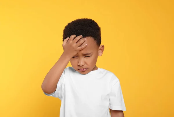 stock image Portrait of emotional African-American boy on yellow background