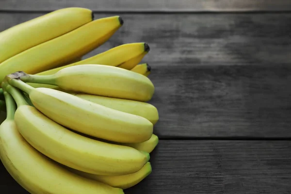 stock image Ripe yellow bananas on wooden table. Space for text