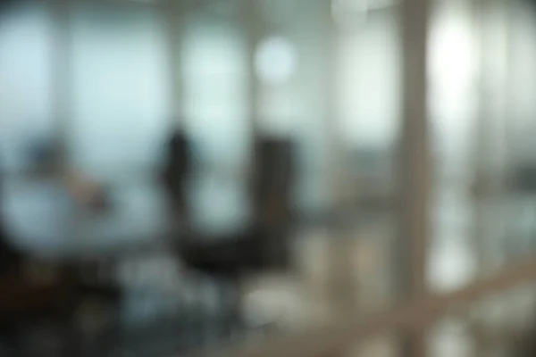 stock image Blurred view of cozy workspaces with tables and chairs in office