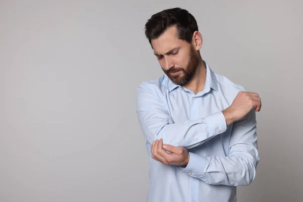 Man Suffering Pain His Elbow Light Background Space Text Arthritis — Stock Photo, Image
