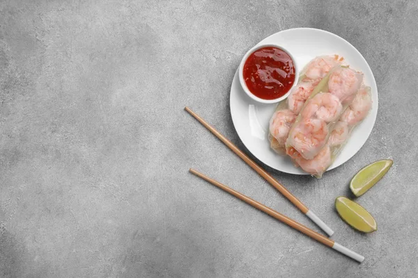 Tasty Spring Rolls Served Sauce Lime Grey Textured Table Flat — Stock Photo, Image