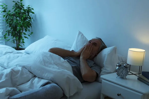 stock image Sleepy senior man in bed at home