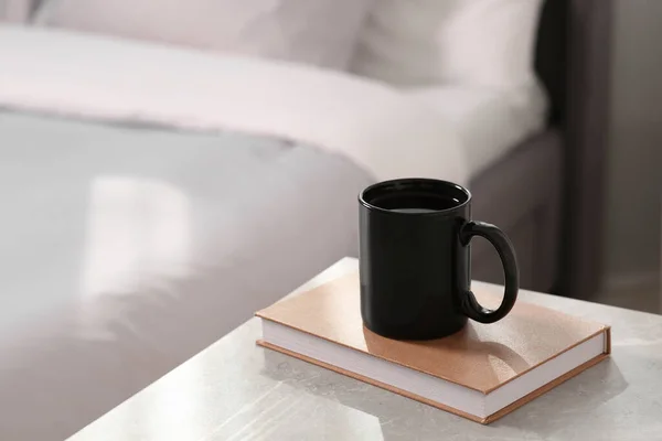 Siyah Seramik Kupa Kitap Kapalı Bir Masada Tasarım Için Model — Stok fotoğraf