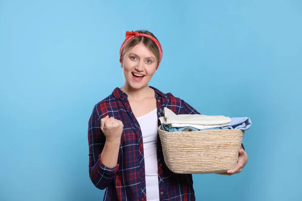 Emotional Woman Basket Full Laundry Light Blue Background — Stock Photo, Image