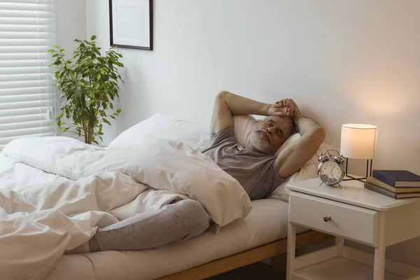 stock image Senior man sleeping in bed at home