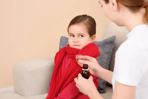 Mother Giving Cough Syrup Her Daughter Measuring Cup Sofa Indoors — Stock Photo, Image