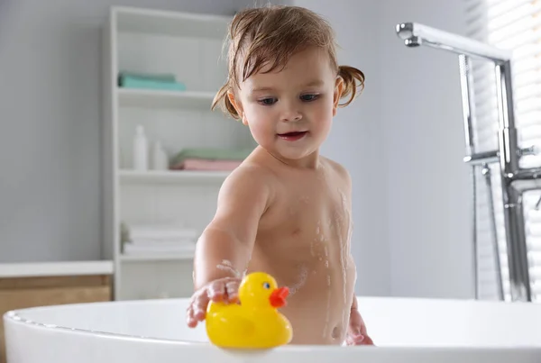 Cute Little Girl Playing Rubber Duck Bathtub Home — Stock Photo, Image