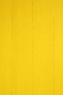 Texture of yellow wooden surface as background, closeup