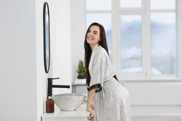 stock image Beautiful happy woman wearing stylish bathrobe in bathroom