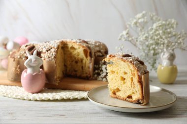 Lezzetli İtalyan Paskalya güvercini pastası (geleneksel Colomba di Pasqua) ve beyaz ahşap masa üzerindeki şenlikli dekor