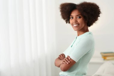 Portrait of smiling African American woman at home. Space for text