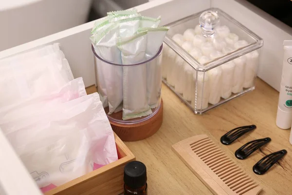 stock image Open cabinet drawer with tampons and feminine hygiene products indoors, closeup