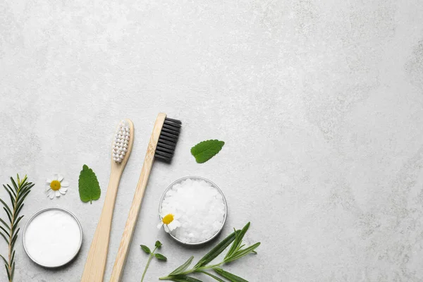 Bamboo Toothbrushes Flowers Herbs Light Grey Table Flat Lay Space — Stock Photo, Image