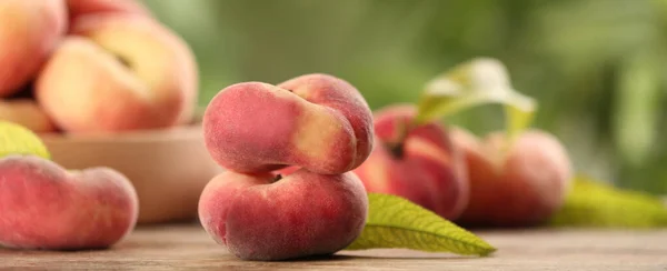 Fresh flat peaches on table. Banner design with space for text