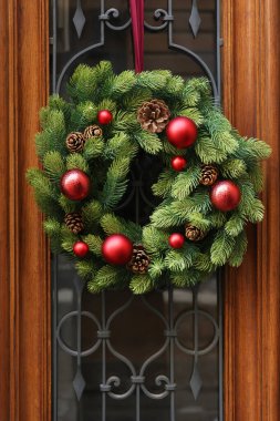 Beautiful Christmas wreath hanging on wooden door