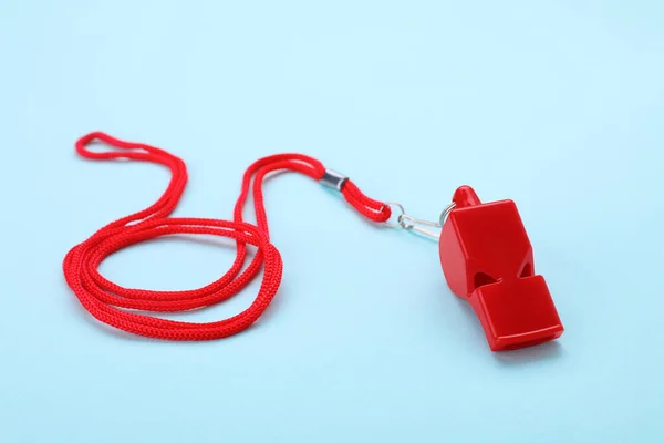 stock image One red whistle with cord on light blue background