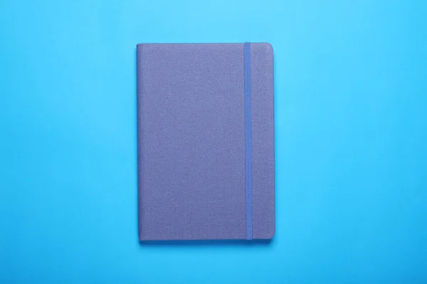Cuaderno Cerrado Sobre Fondo Azul Claro Vista Superior —  Fotos de Stock