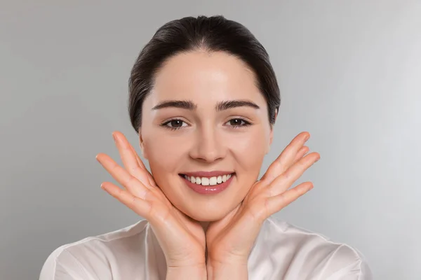Young Woman Massaging Her Face Grey Background — Foto Stock