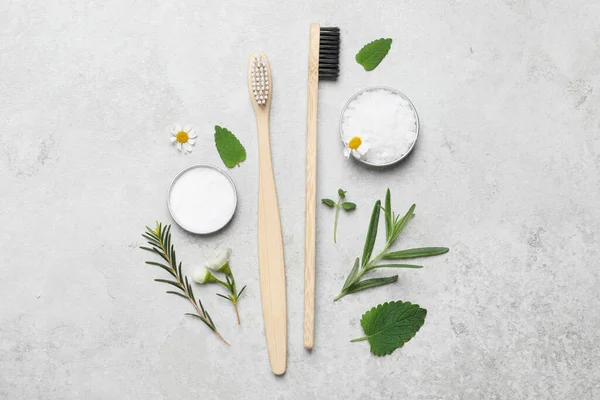 Bamboo Toothbrushes Flowers Herbs Light Grey Table Flat Lay — Stock Photo, Image