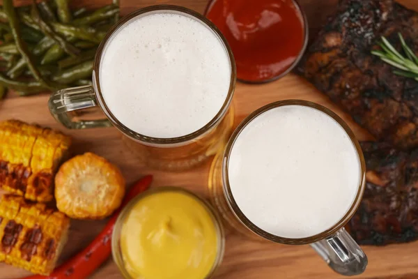 Mokken Met Bier Heerlijke Gegrilde Ribbetjes Ingrediënten Houten Tafel Close — Stockfoto