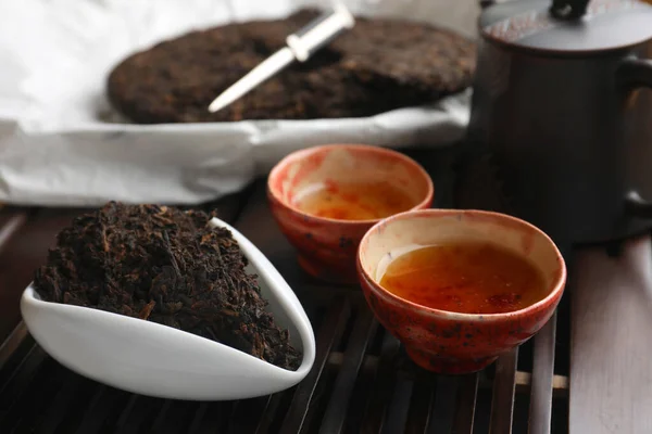 stock image Aromatic pu-erh on wooden tray, closeup. Fermented tea