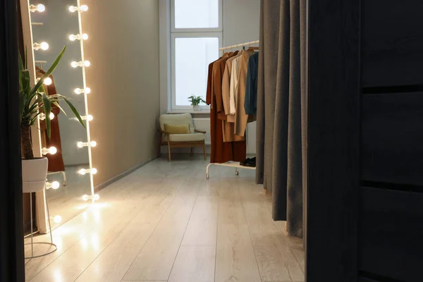 Dressing room with clothes rack and mirror. Interior design