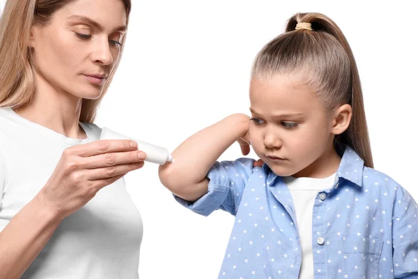 Mother Applying Ointment Her Daughter Elbow White Background — Stock Photo, Image