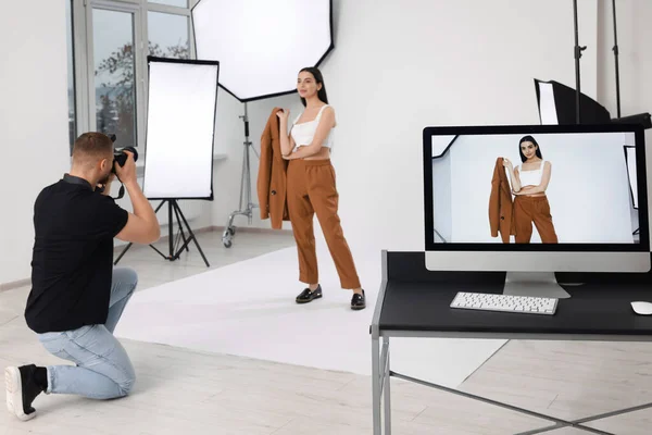 stock image Professional photographer working with beautiful model in modern photo studio