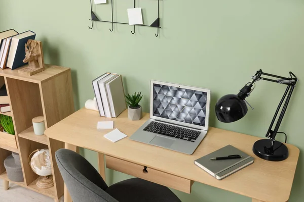 Modern Laptop Books Lamp Stationery Wooden Desk Green Wall Home — Stock Photo, Image