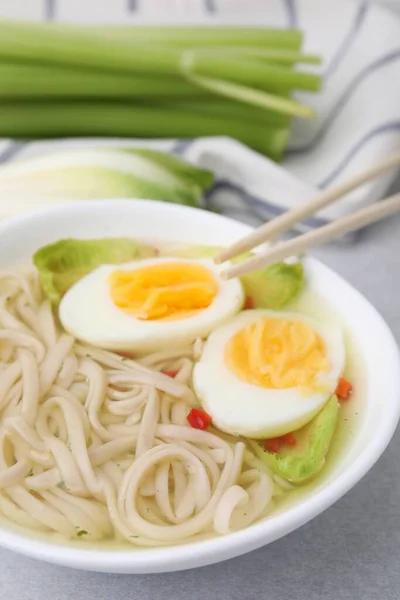 Bowl Delicious Rice Noodle Soup Celery Egg Light Grey Table — Stock Photo, Image