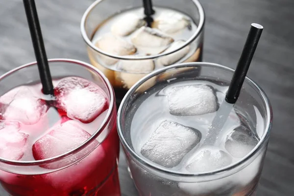 Gri Masa Üzerinde Buz Küpleri Pipetlerle Farklı Tazeleyici Soda Bardakları — Stok fotoğraf