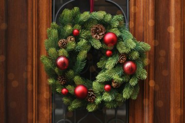 Beautiful Christmas wreath hanging on wooden door