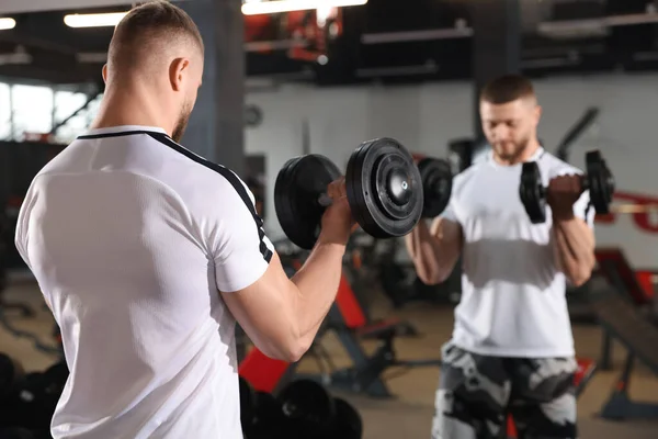 Man Training Dumbbells Mirror Gym —  Fotos de Stock