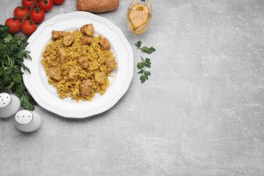 Açık gri masada servis edilen tavuklu leziz pilav. Metin için boşluk